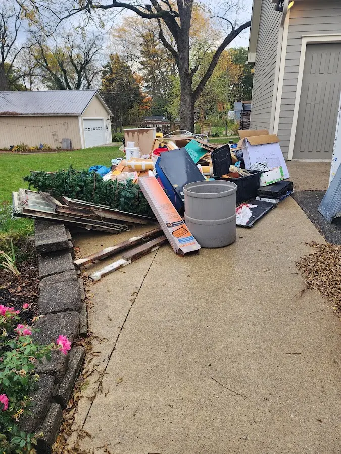Dumpster being loaded with debris for Roofing Dumpster Rental in Wilmington